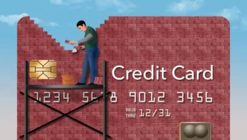 Man building credit card out of bricks