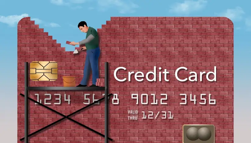 Man building credit card out of bricks